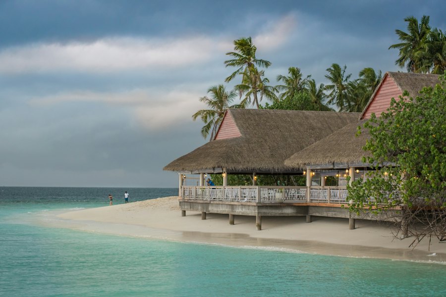Thatched overwater-style building on a white sand spit in the Maldives